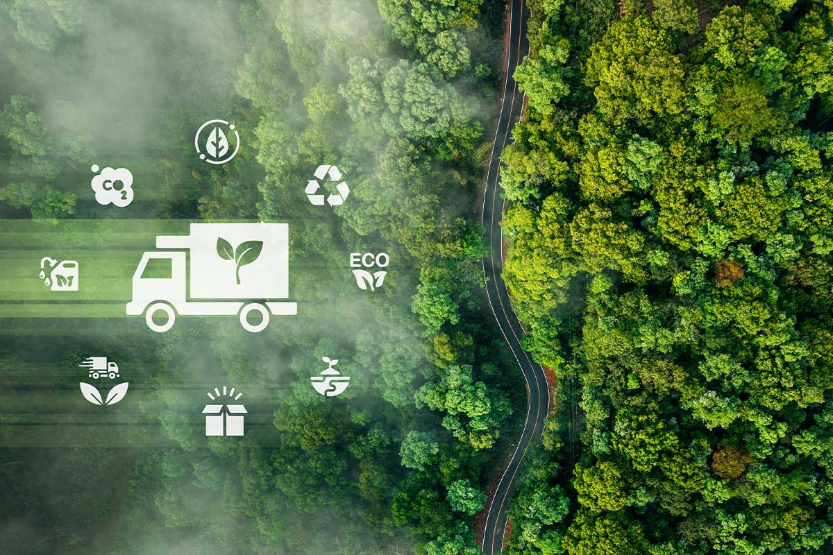 Eine Applikation eines Lastwagen mit umwelfreundlichen Symbolen. Auf der rechten Seite ist ein Wald und eine vertikal verlaufende Straße
